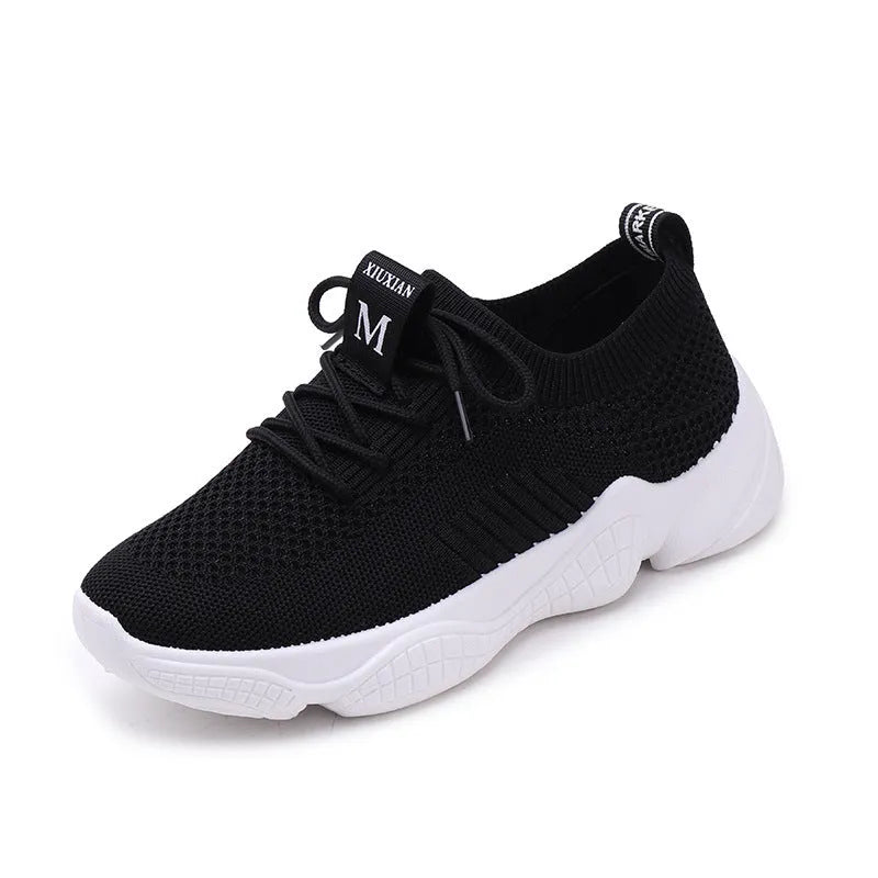 Women's white fly knit slip-on sport shoes with a thick rubber sole and front strap.