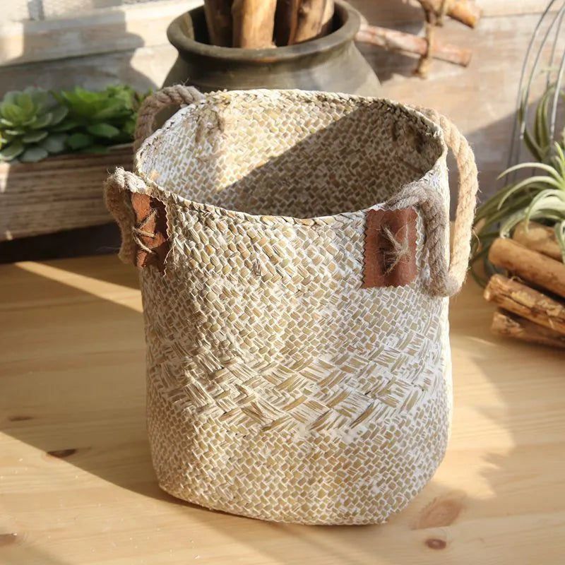 Hand woven seagrass basket in brown, size L, on a wooden surface