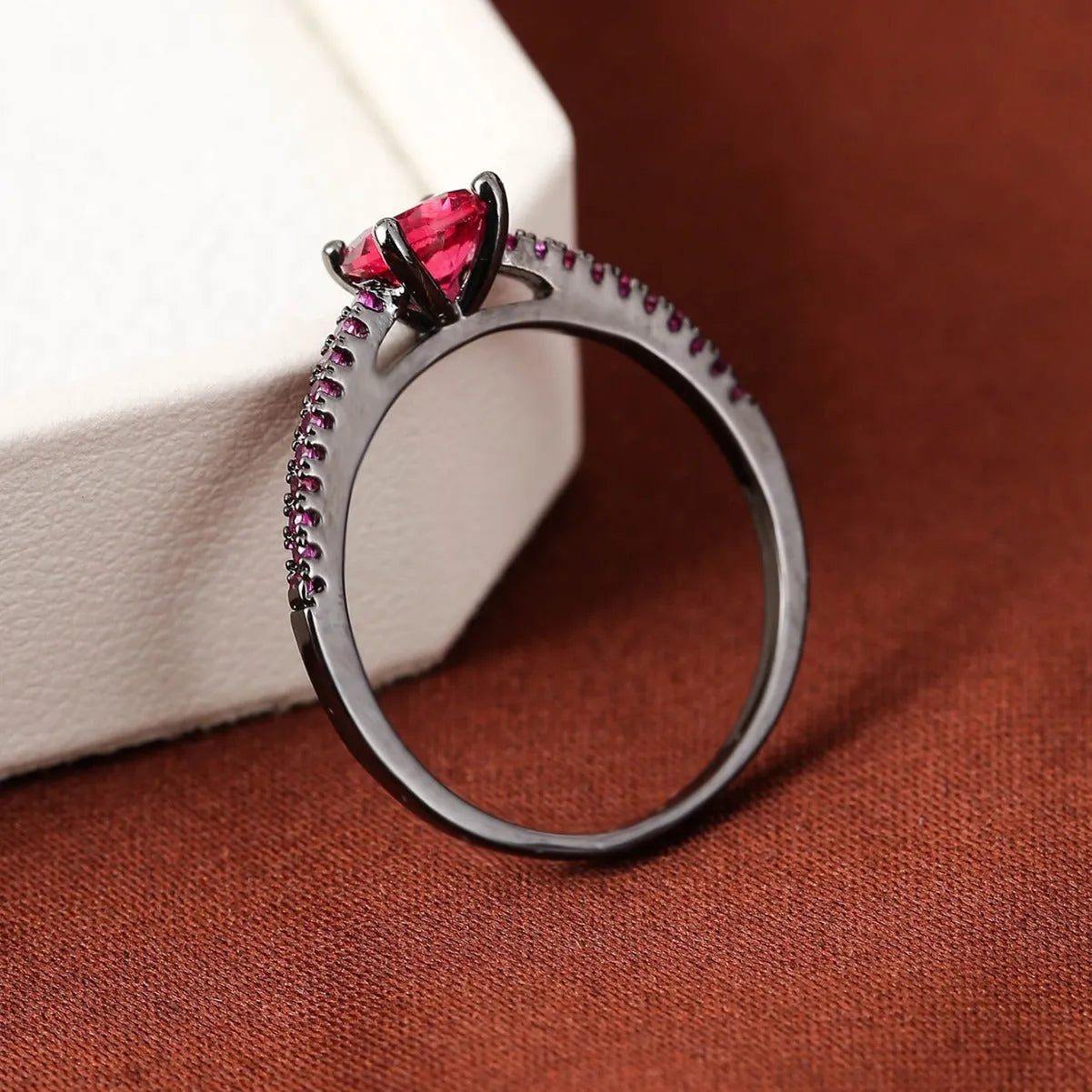 Geometric hexagonal copper ring in a silver white electroplated finish on a hand.