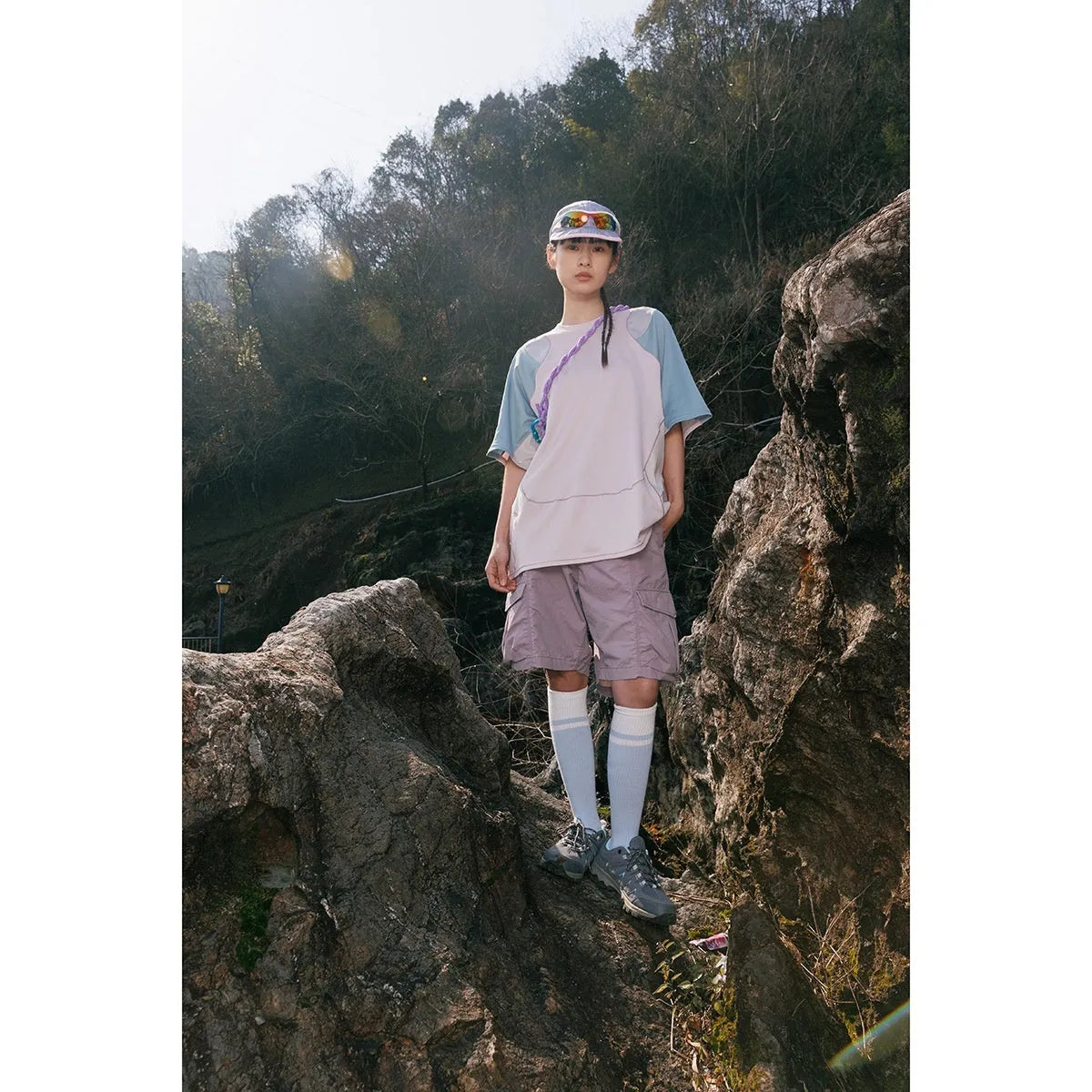 Men's loose blue short sleeve t-shirt with raglan sleeves on a hanger.