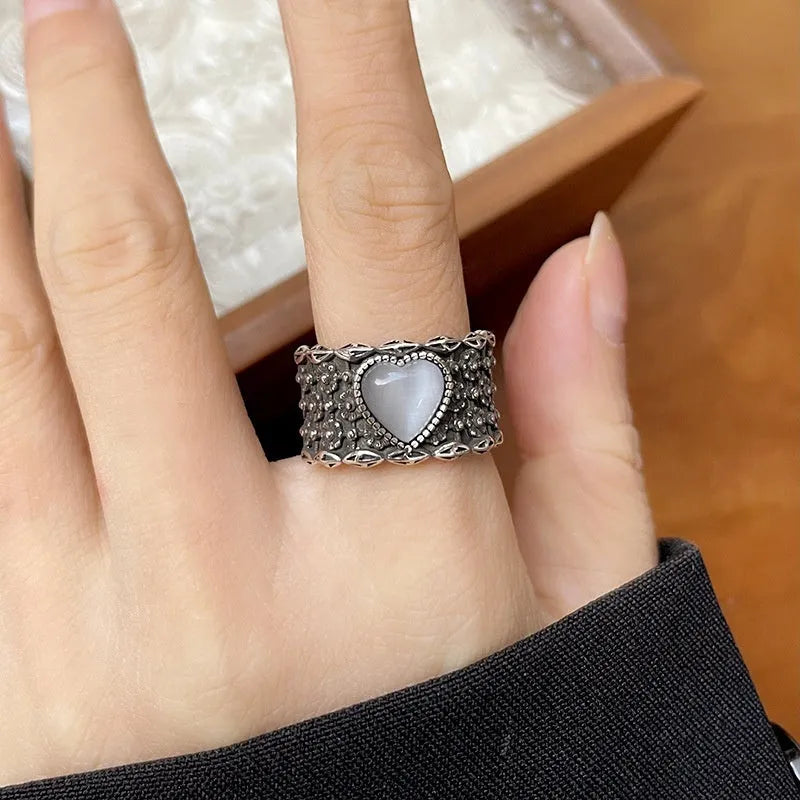 Adjustable opening love heart ring in white or green colour with retro wide-faced design