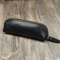 Black genuine leather pencil case with zipper closure measuring 18cm