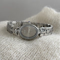 Oval women's casual watch with gold strap and white dial, metal case, quartz movement