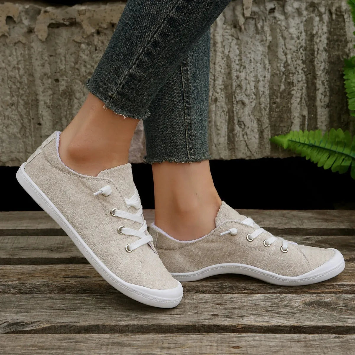 Women's low-top beige fabric casual sneakers on a white background.