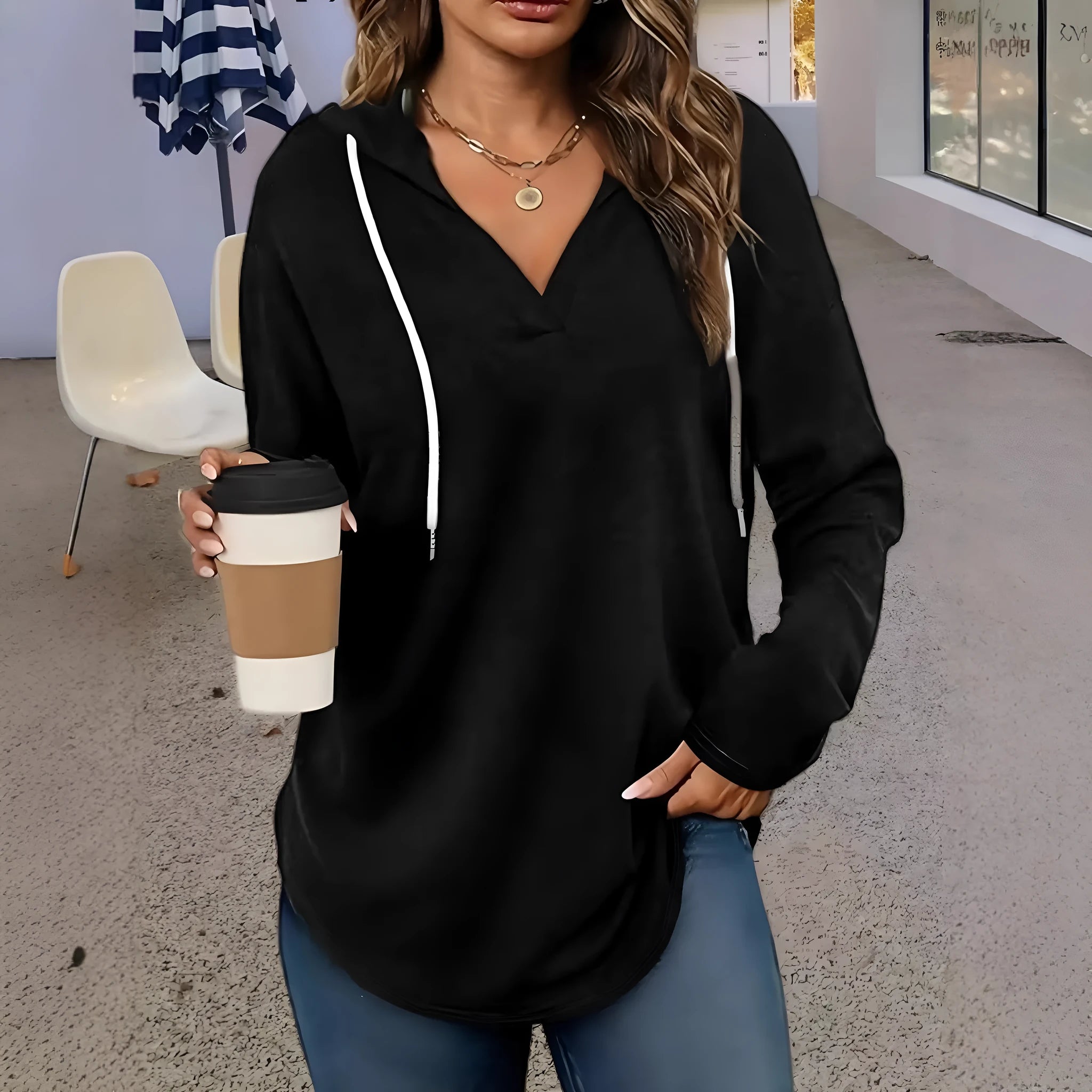 Red women's hooded V-neck sweatshirt with long sleeves on a hanger.