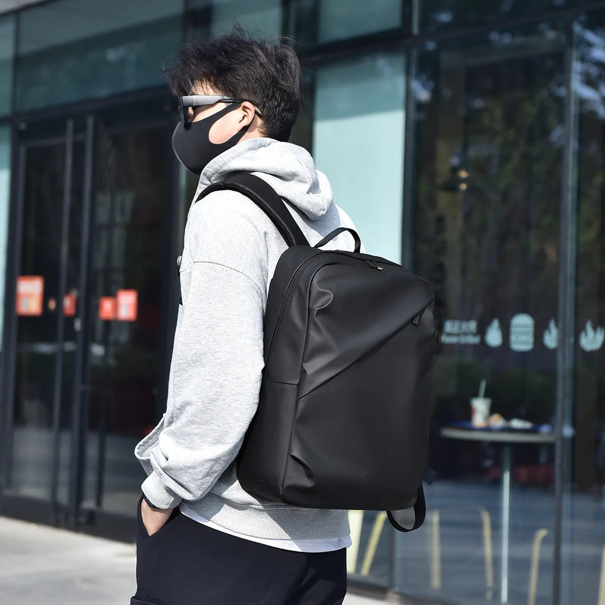 Men's waterproof PU leather backpack in black colour with computer compartment and sewing thread details