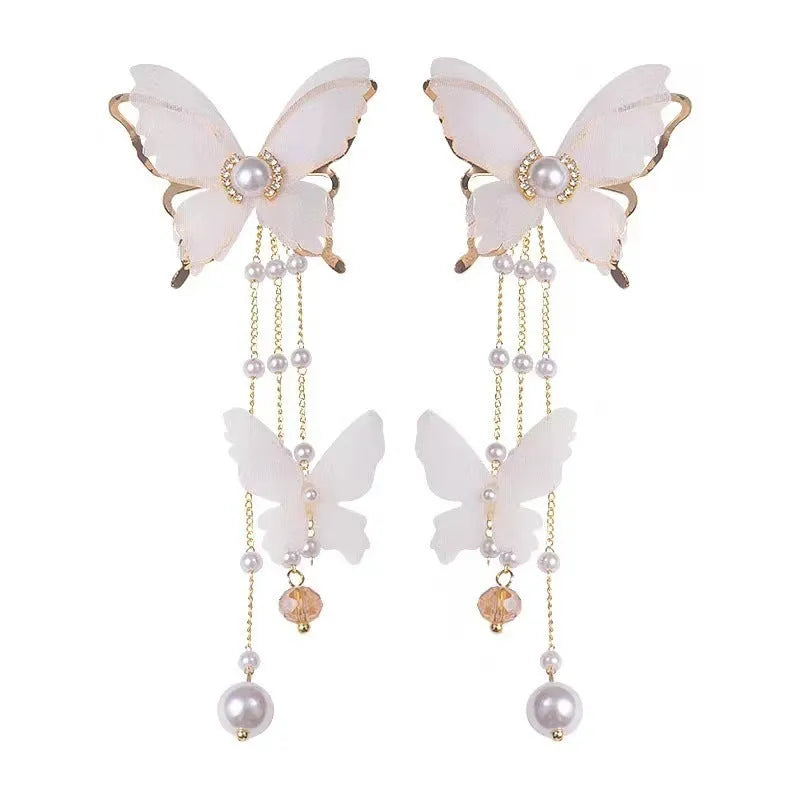 White butterfly earrings with tassel lace and pearl rhinestone decorative elements on copper alloy