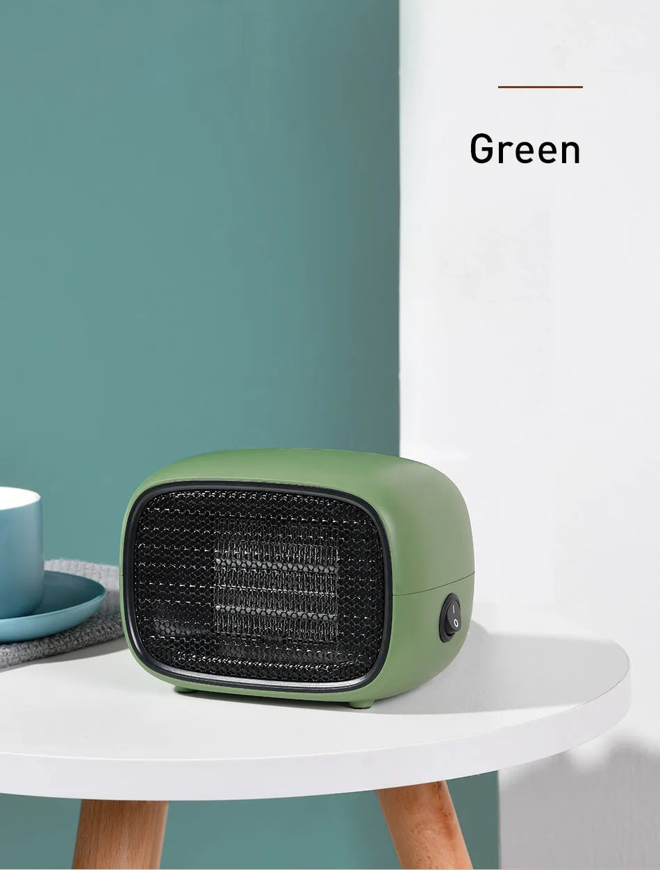 Green mini ceramic space heater with EU plug on a wooden desk