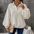 Beige women's textured knit sweater with a polo collar and long sleeves.