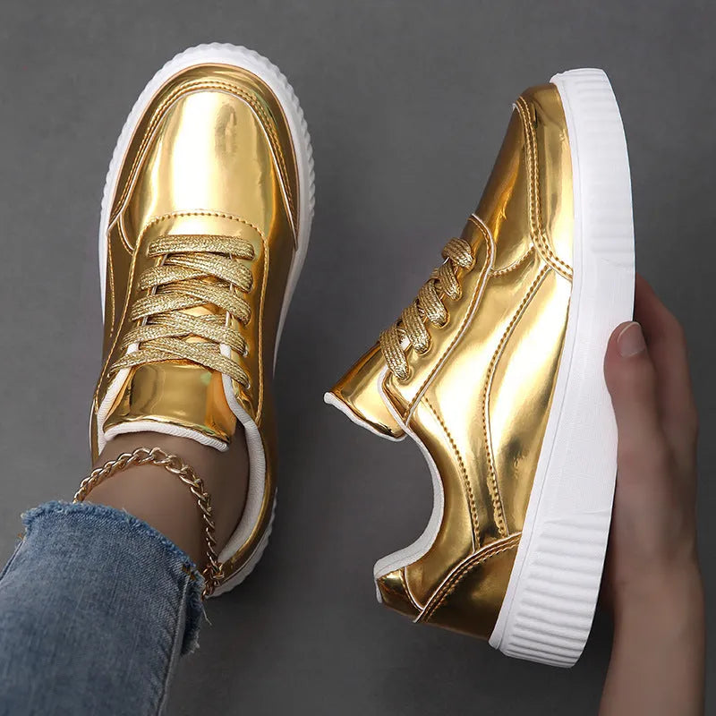 Gold sequinned platform sneakers with round toe and thick MD sole on white background.