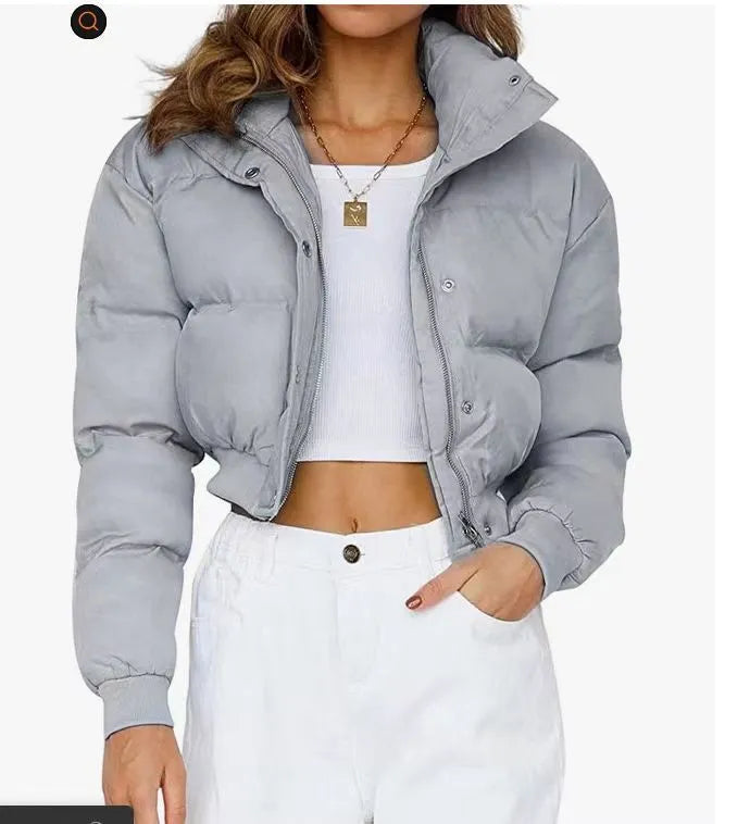 A woman's loose-fitting long-sleeve polyester jacket in blue, shown on a hanger.