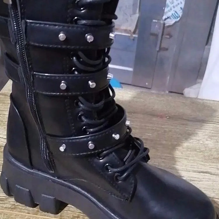 Black mid-calf women's boots with a large metal buckle and side zip on a white background.