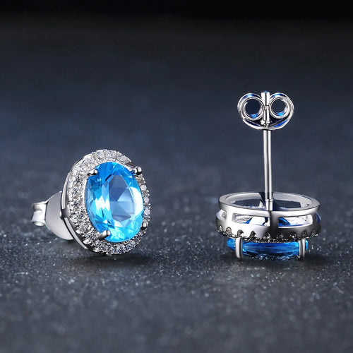 925 sterling silver jewellery set with blue topaz stones showing earrings, ring, pendant and necklace in geometric design