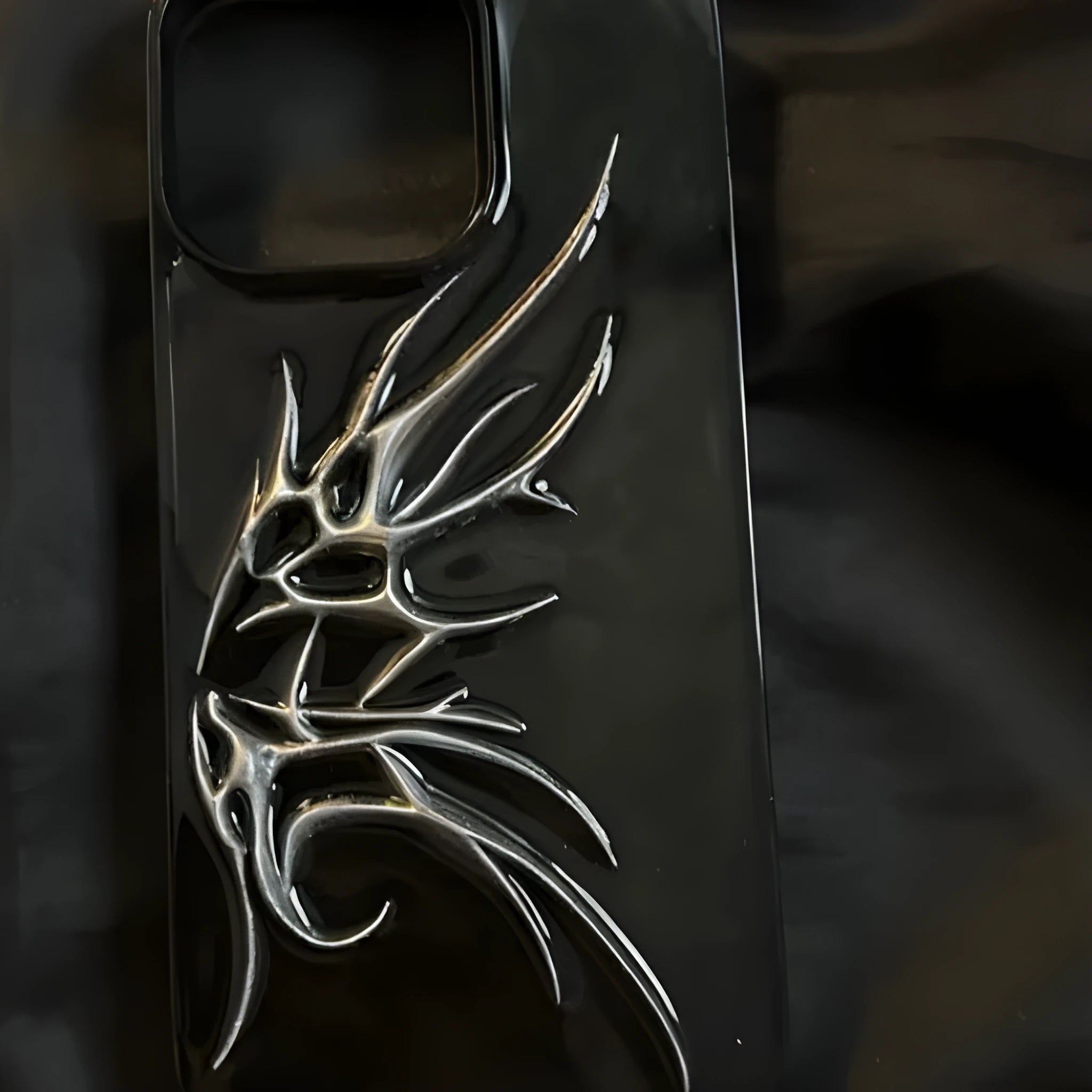 iPhone protective case featuring a raised three-dimensional wings design in a blurred wings colour.