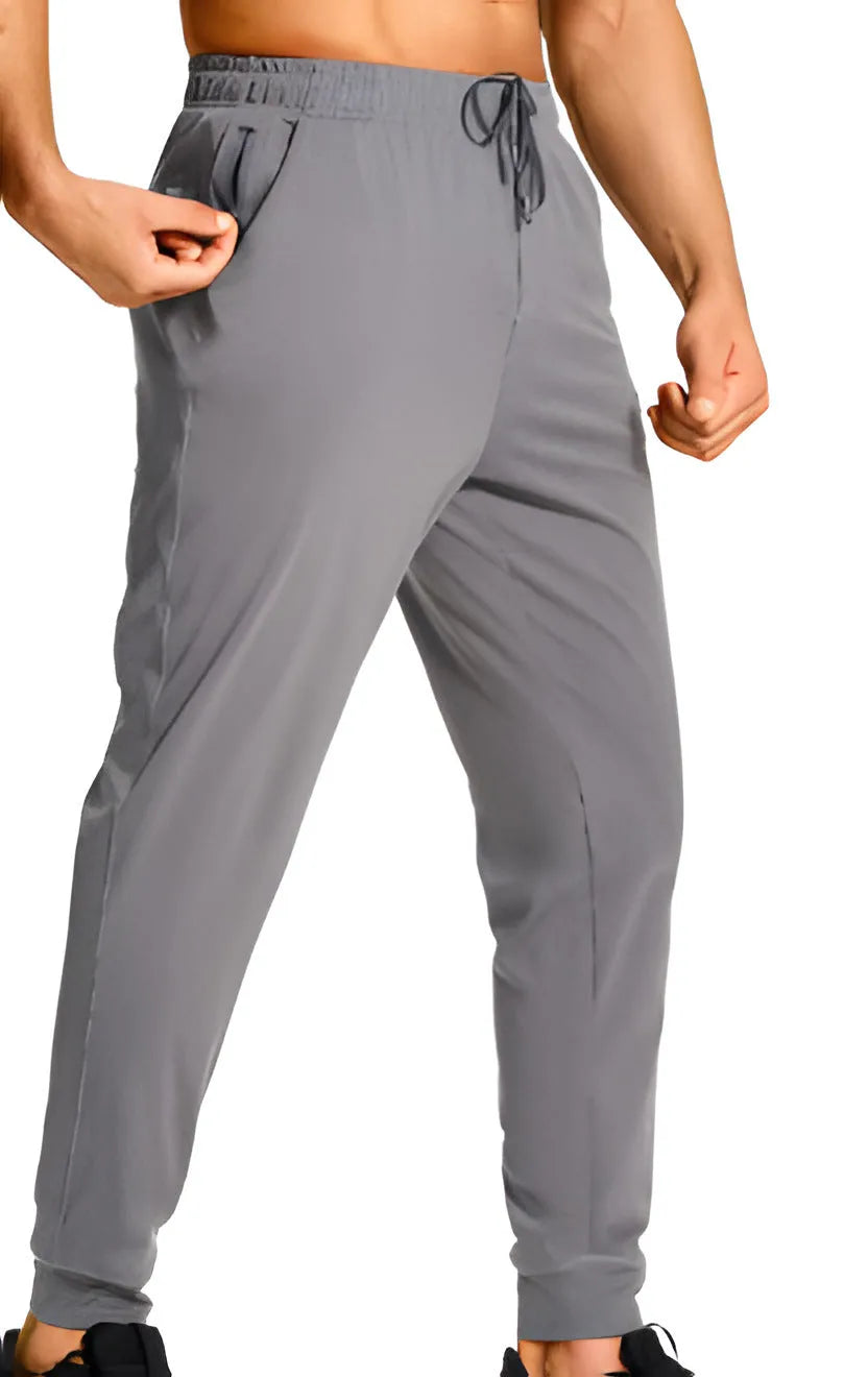 Men's loose fit solid colour casual trousers in polyester fabric on a hanger.