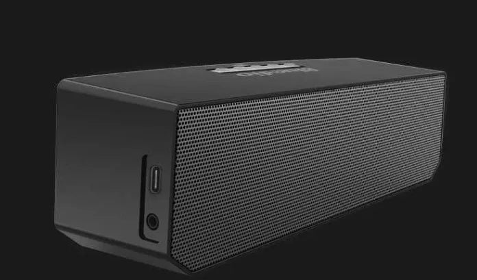 Black rectangular smart speaker with AI voice assistant, showing front grille and micro-USB port.