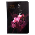 A5 notebook with luminous illustrated cover in blue, shown open on a desk.