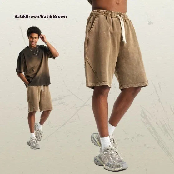 Man's loose-fit cotton terry shorts in a batik wash colour, showing street-style casual design.