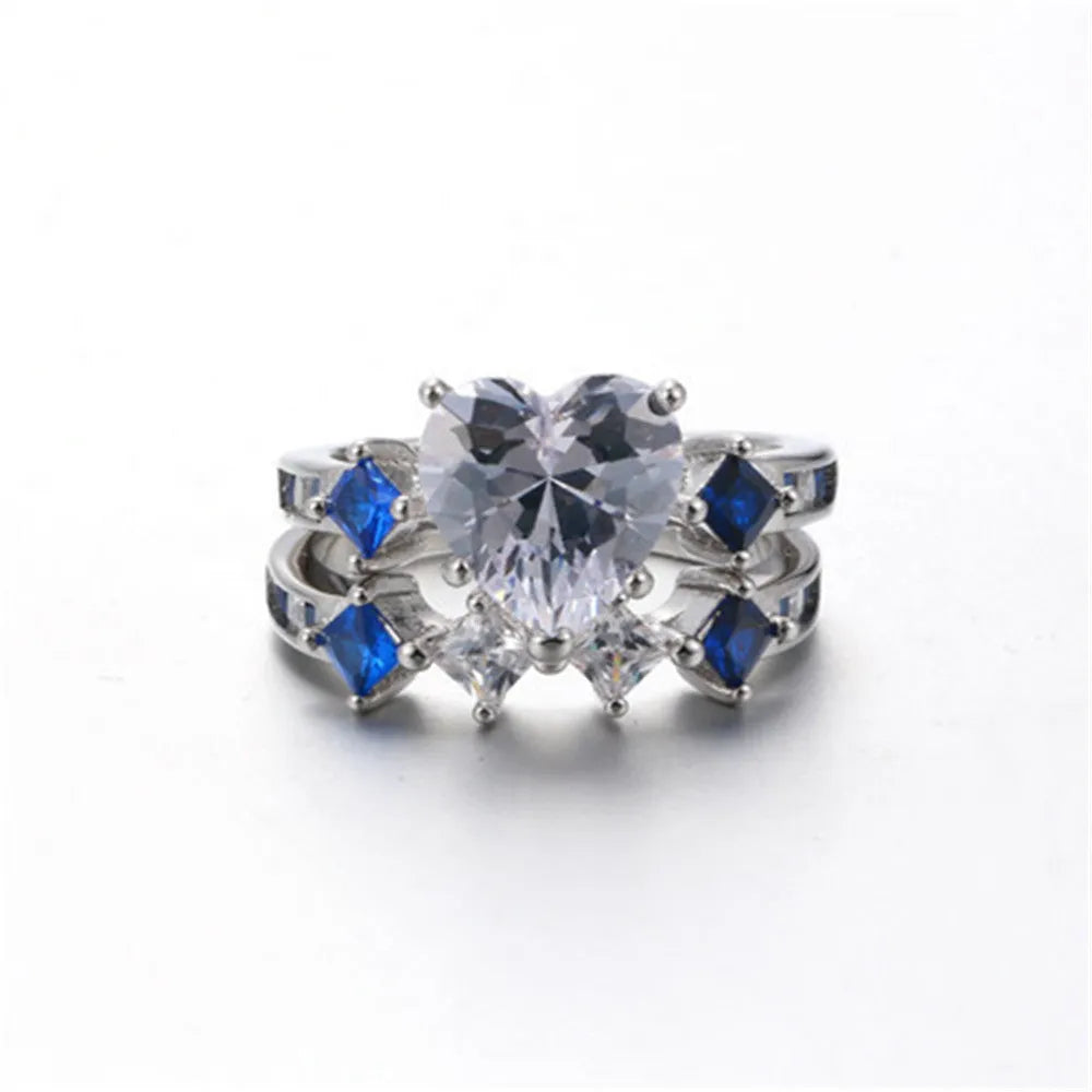 Silver-tone alloy heart-shaped geometric ring set on hand showing silver finish and multiple rings