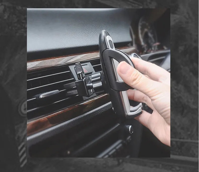 Black plastic mobile phone holder attached to car air conditioning vent