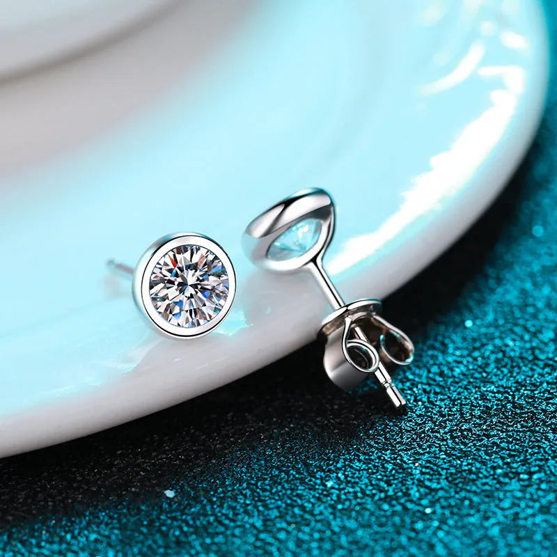 Gold-plated geometrical stud earrings with moissanite or zircon stone on a white background.
