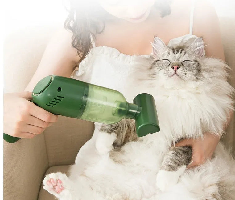 Electric cat and dog hair suction cleaner in green, USB powered, 244x72x157mm, with two suction heads on a fabric surface.