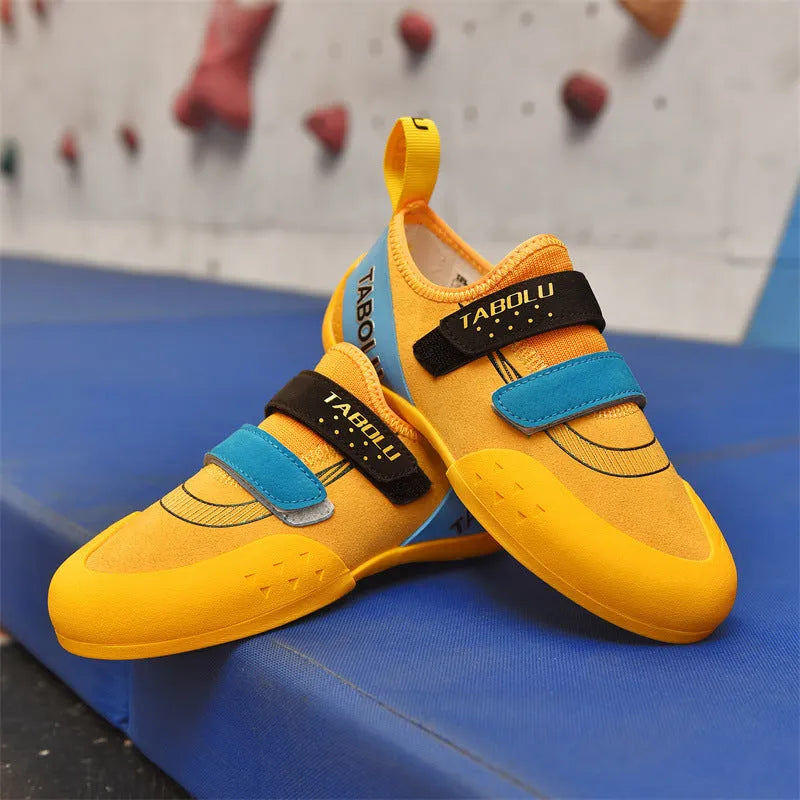 Beginner rock climbing shoes with Velcro straps and non-slip rubber soles in black/red colour