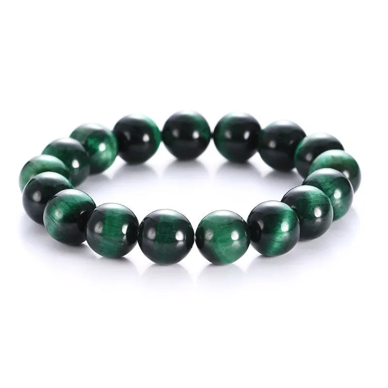 Green Tiger Eye stone bracelet with polished geometry beads on a wrist.