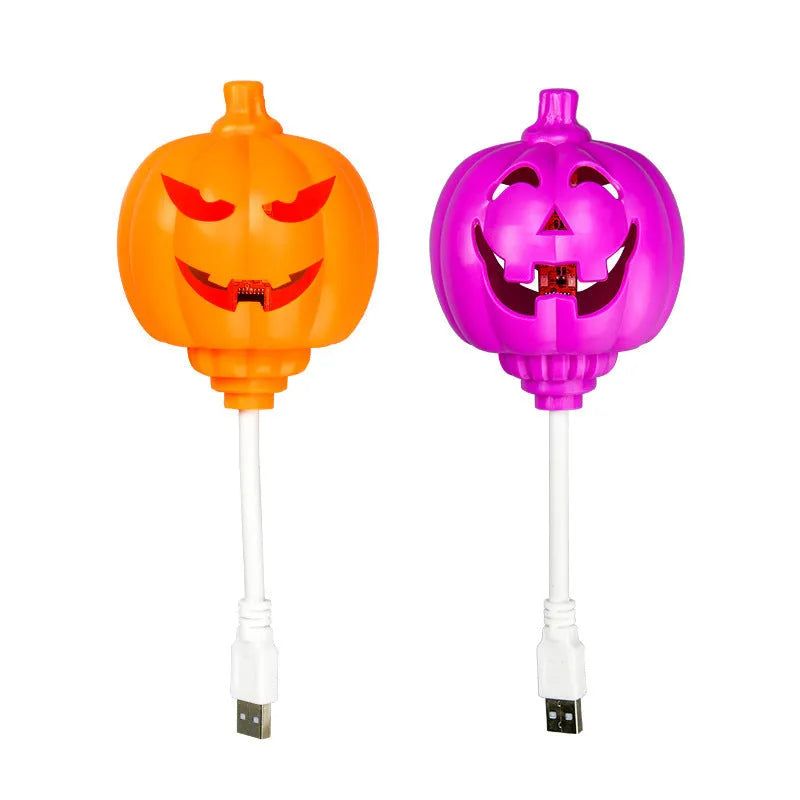 A plastic pumpkin lamp with a USB port, glowing in either yellow or purple light.