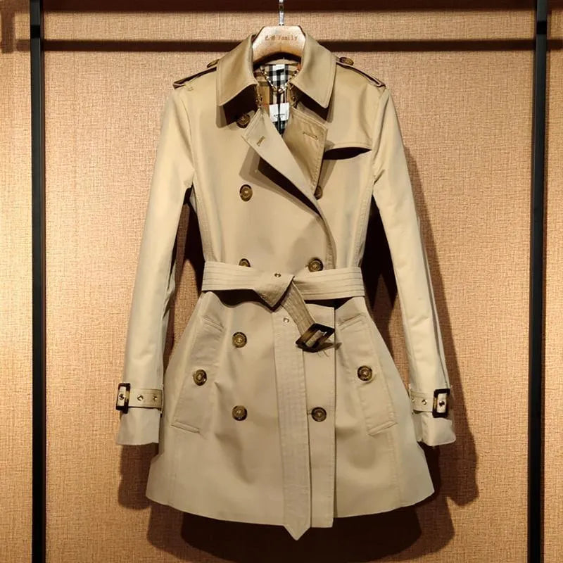 Khaki double-breasted polyester trench coat for women with flight sleeves on a hanger.