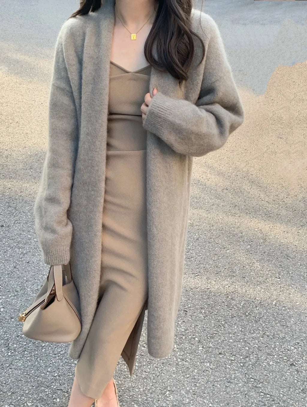 Women's loose fit grey knitted cardigan with V-neck and long sleeves, mid-length style.