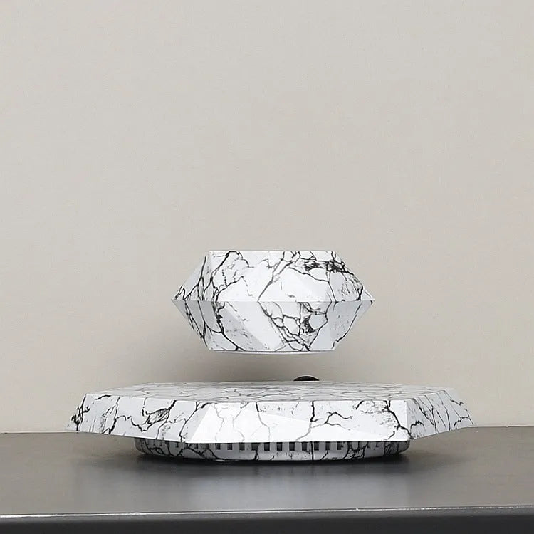 Marbled colour levitating plant pot floating above base with magnetic technology