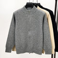 Men's black knitted cardigan with a stand collar and full-length front zipper, shown in a loose fit.