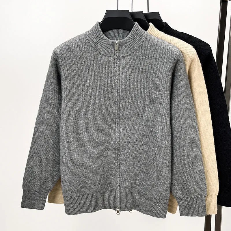 Men's black knitted cardigan with a stand collar and full-length front zipper, shown in a loose fit.