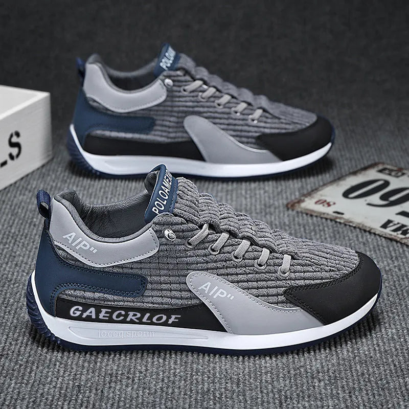 Men's grey and green mesh sports trainers with lace-up front and round toe.