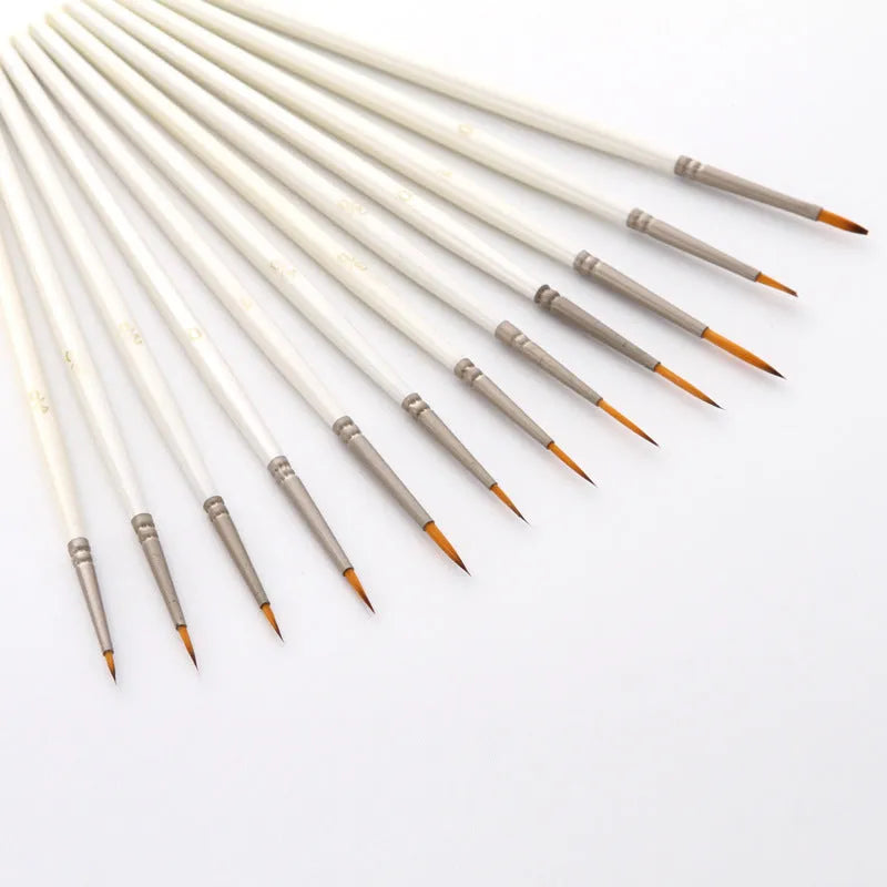 A 12-piece set of Pearl White artist brushes with a solid wood pen holder.