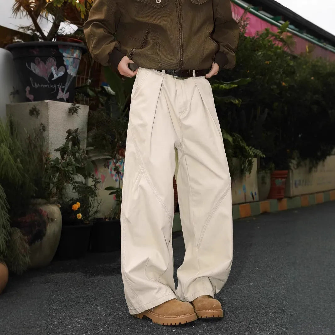 Men's pleated straight-leg loose trousers in apricot colour showing front detail and micro-elastic waistband.