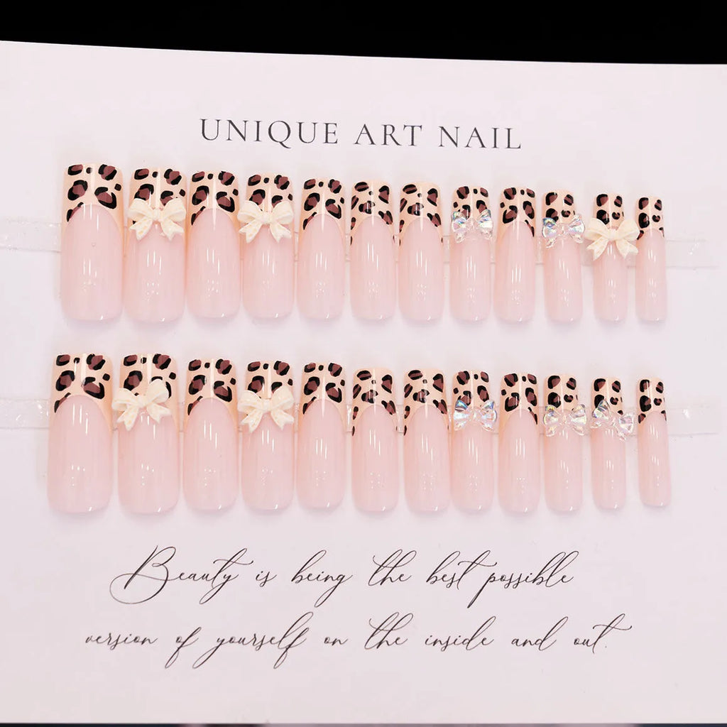 Leopard print butterfly shaped nail art decals on a plastic sheet.