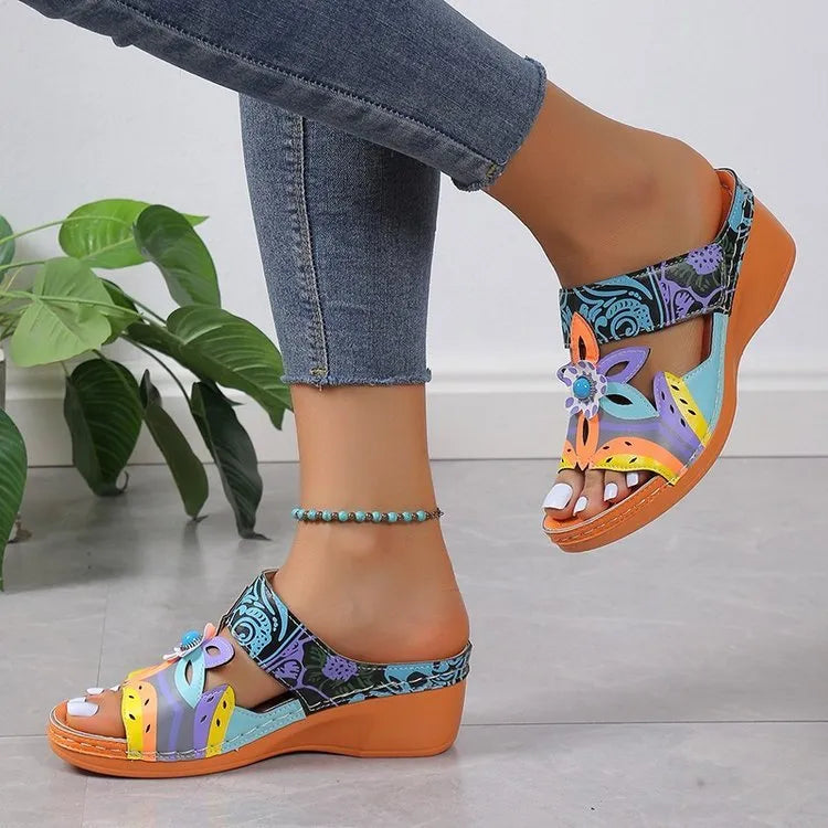 Ethnic patterned slippers with coloured slope design in cowhide, showing round toe and rubber sole.