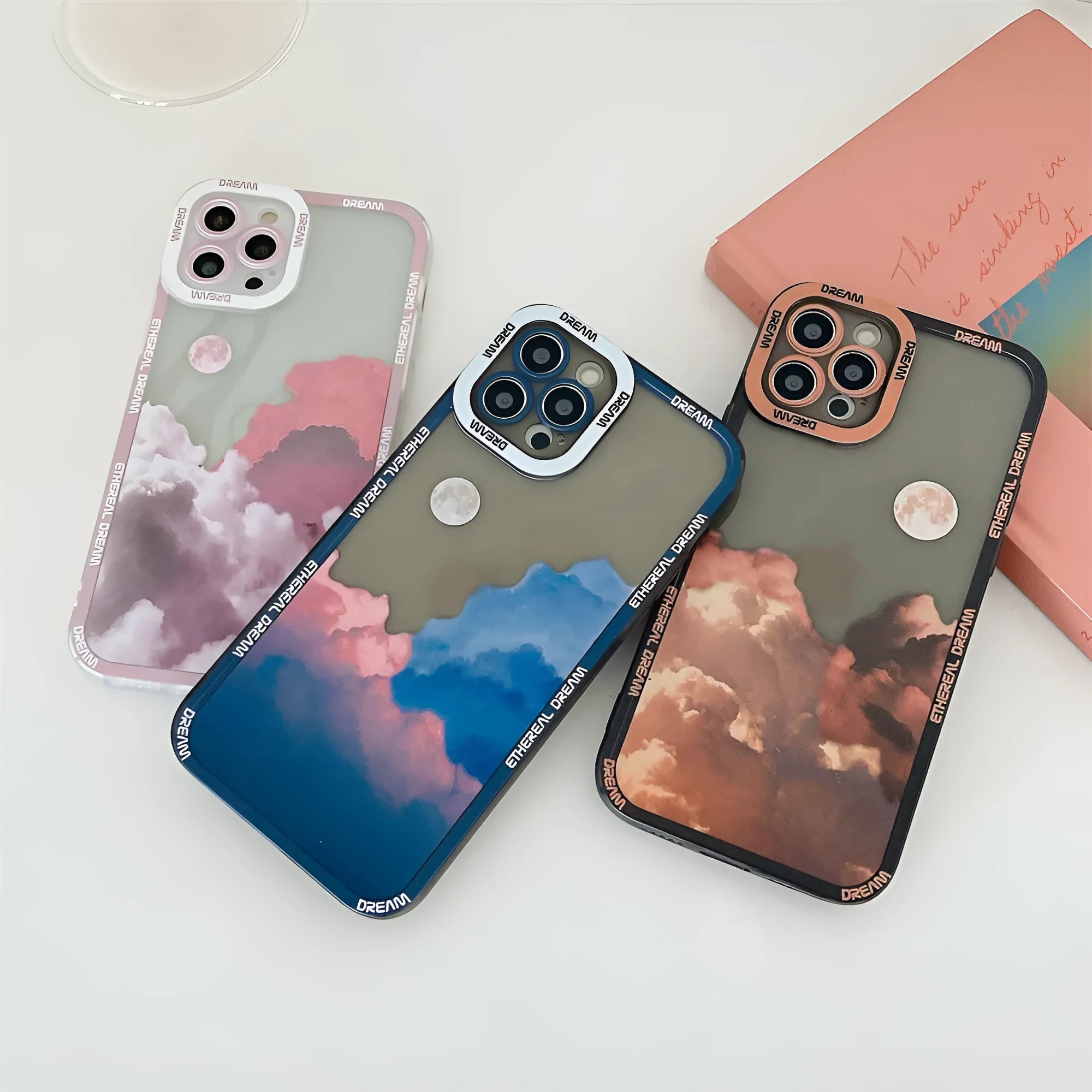 Sunset clouds design TPU phone case for iPhone models showing orange, pink, and blue colour options