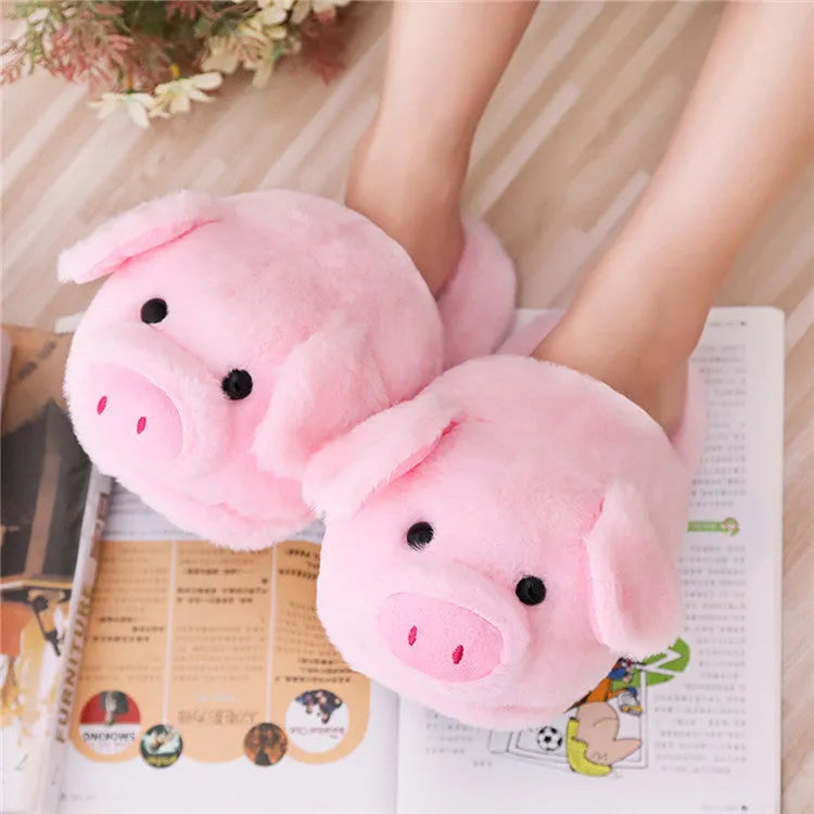 Pink plush pig face design floor slippers on a white background.