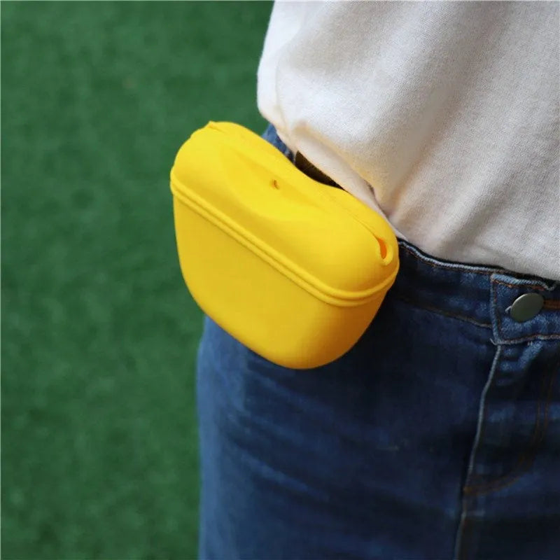 A silicone pet treat waist bag with a clip and magnetic flap closure in various colours.