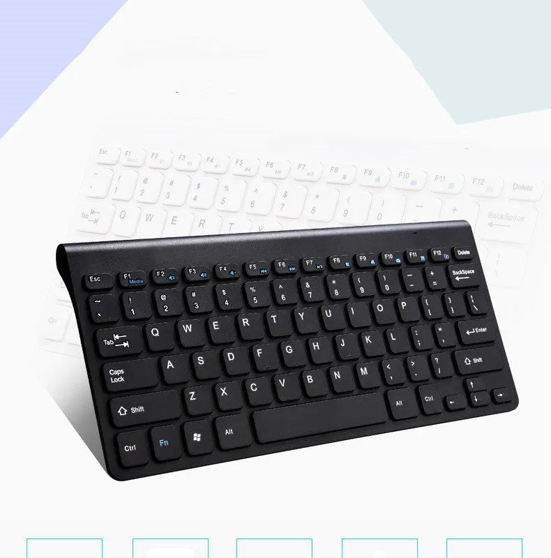 Black and white wireless keyboard and mouse set on a wooden desk.