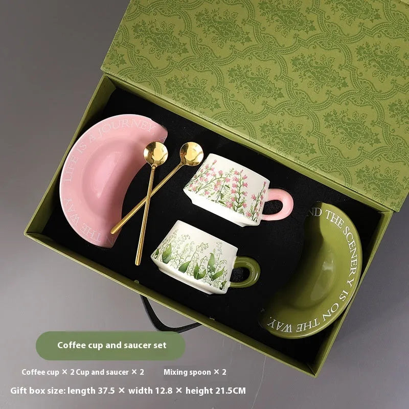 Ceramic coffee cup and saucer set for two in campanula floral design with stirring spoons