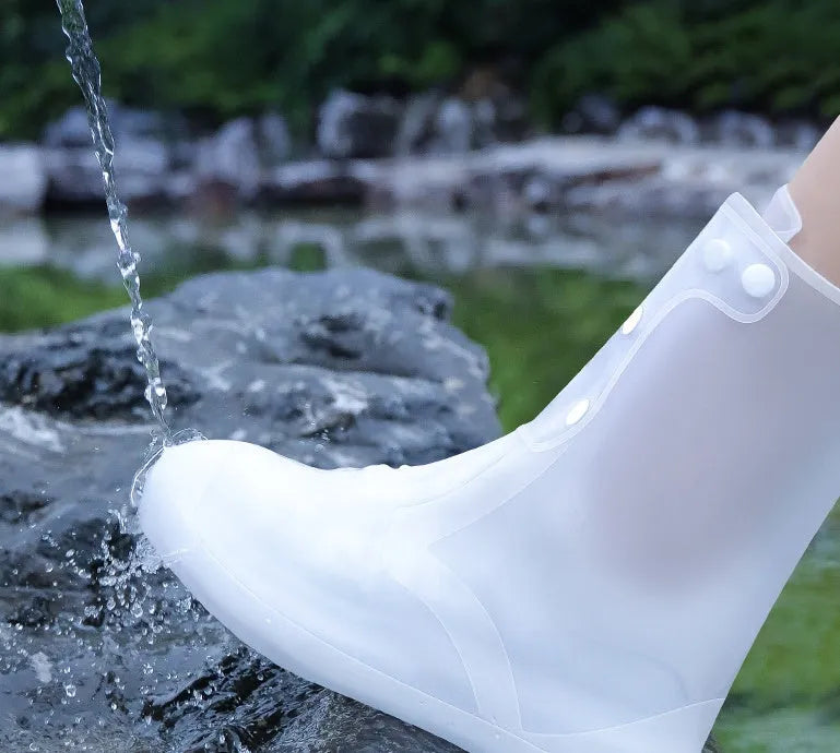 Women's white PVC high top reusable waterproof shoe covers shown on feet