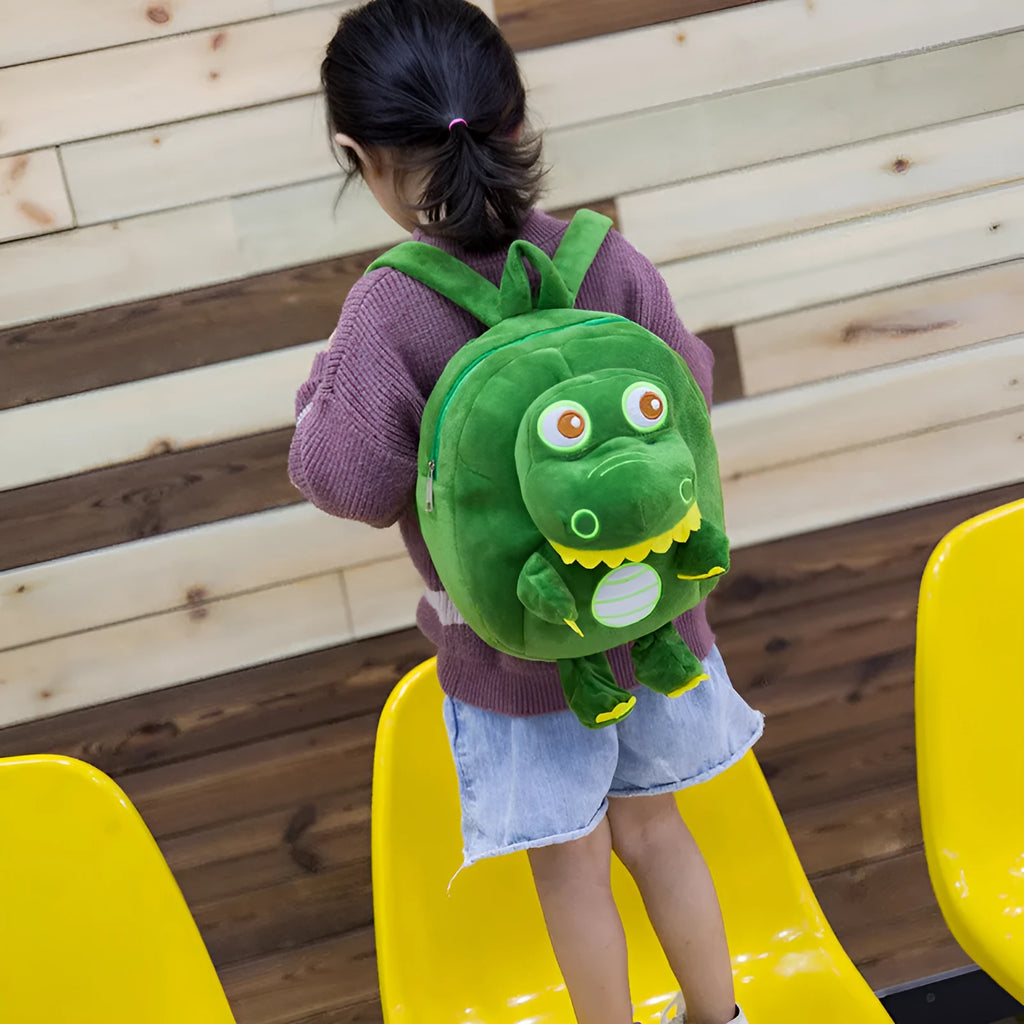 Blue soft plush dinosaur character backpack for children with embroidery, a soft handle, and backpack straps.