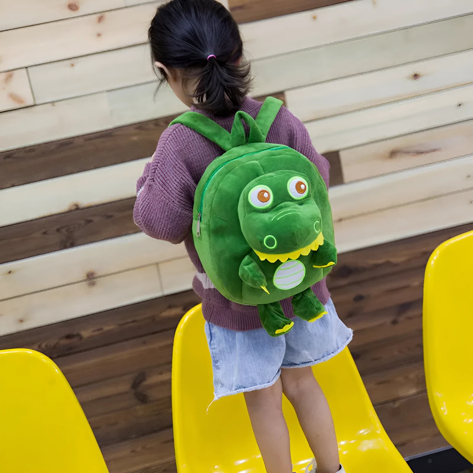 Blue soft plush dinosaur character backpack for children with embroidery, a soft handle, and backpack straps.