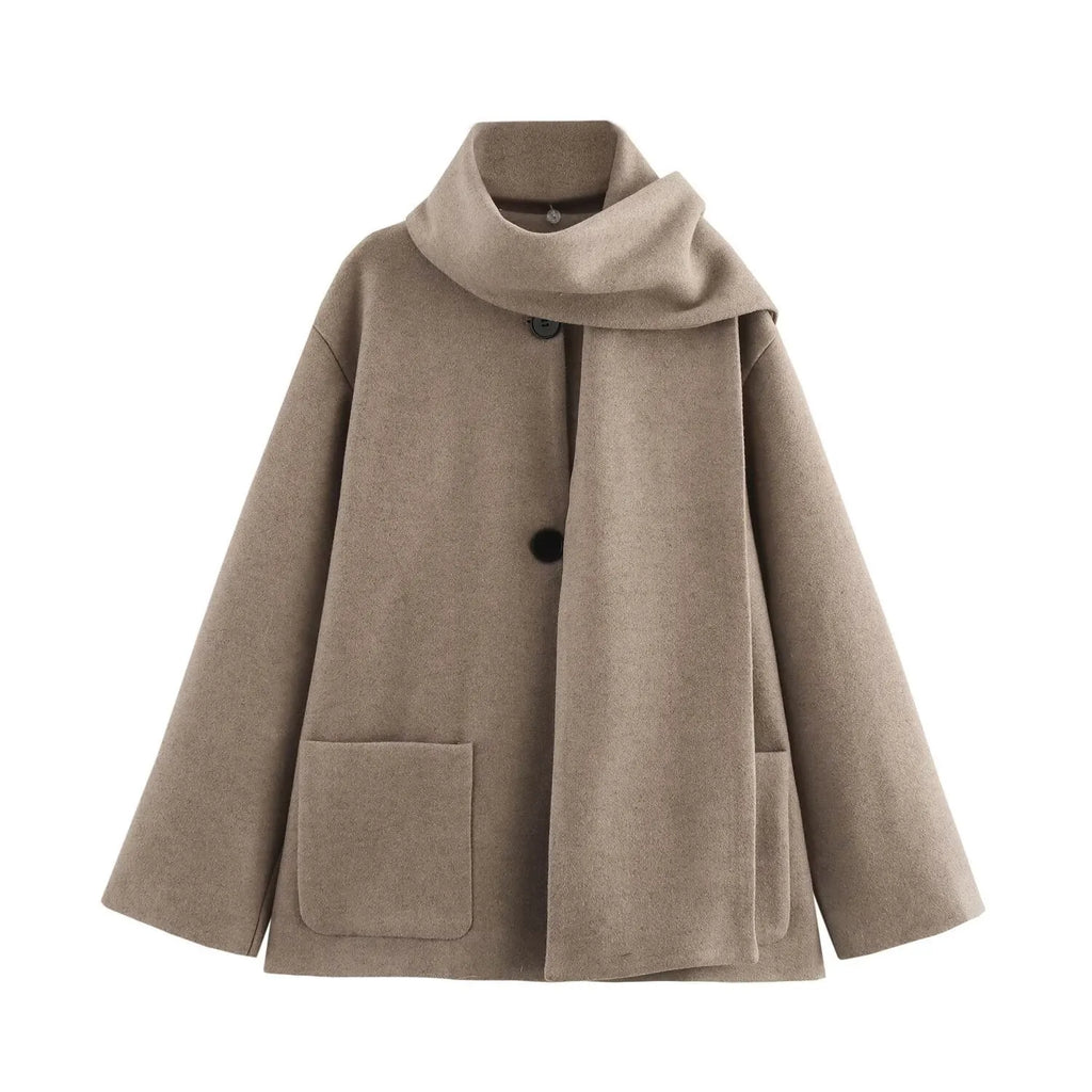 Women's long black overcoat with artificial fur collar, showing extended length and street fashion style.