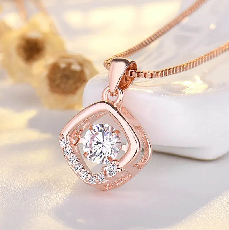 Silver or rose gold plated heart pendant necklace for women with crown and bow detailing on a chain.