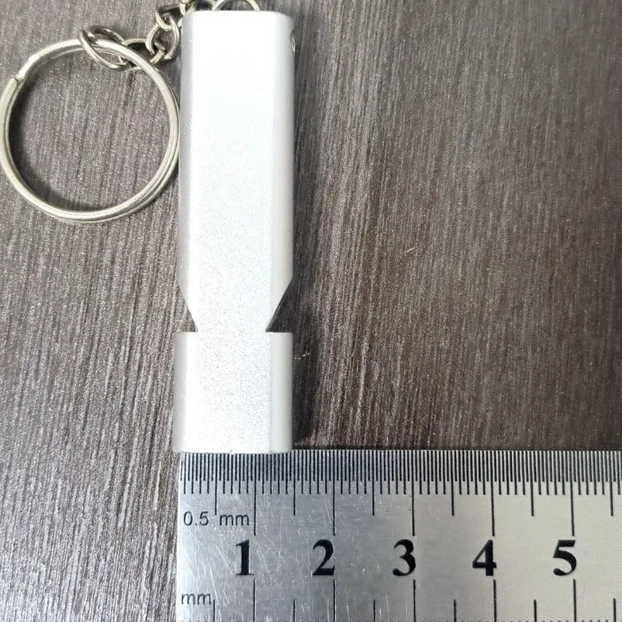 Silver and gold aluminium alloy double hole outdoor survival whistle.